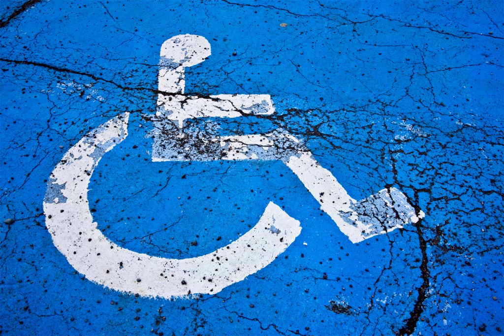 Handicapped sign depicted white wheelchair on blue graphic