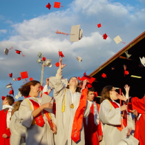 Graduates throw hats up in the air