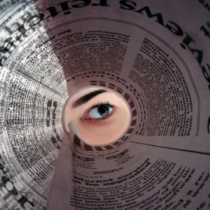 eye looking through a rolled up newspaper like a telescope